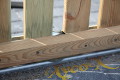 Laufrolle für Laufschienen, versenkt verbaut bei einem Geländer - Schiebetor aus Holz